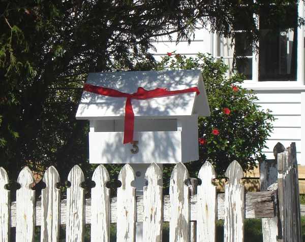 white letterbox and picket fence