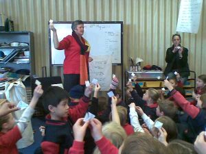 Claire Saxby with children making paper boats