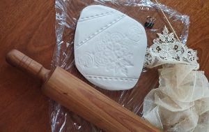 lace imprint in clay using rolling pin